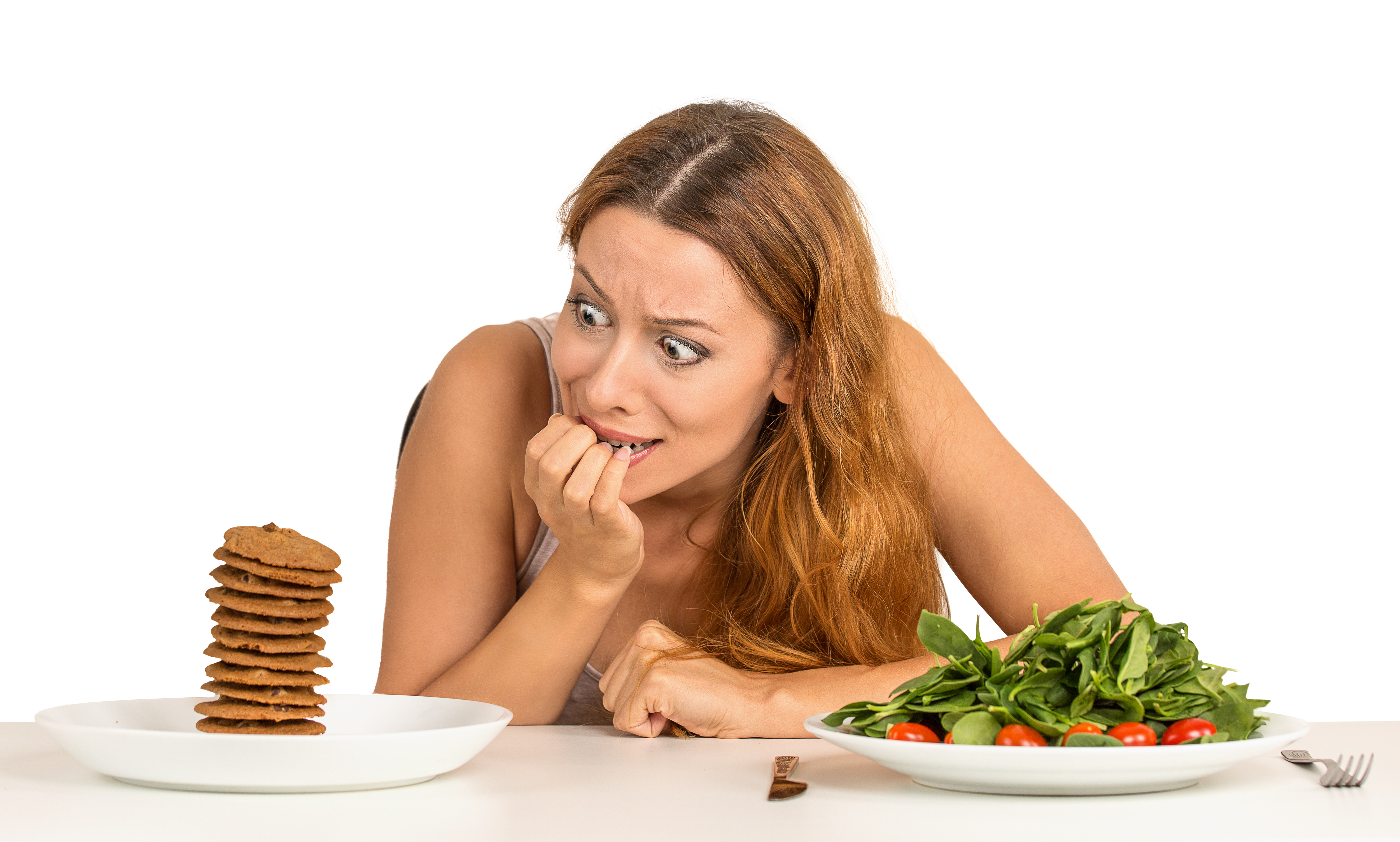 Portrait young woman deciding whether to eat healthy food or sweet coo